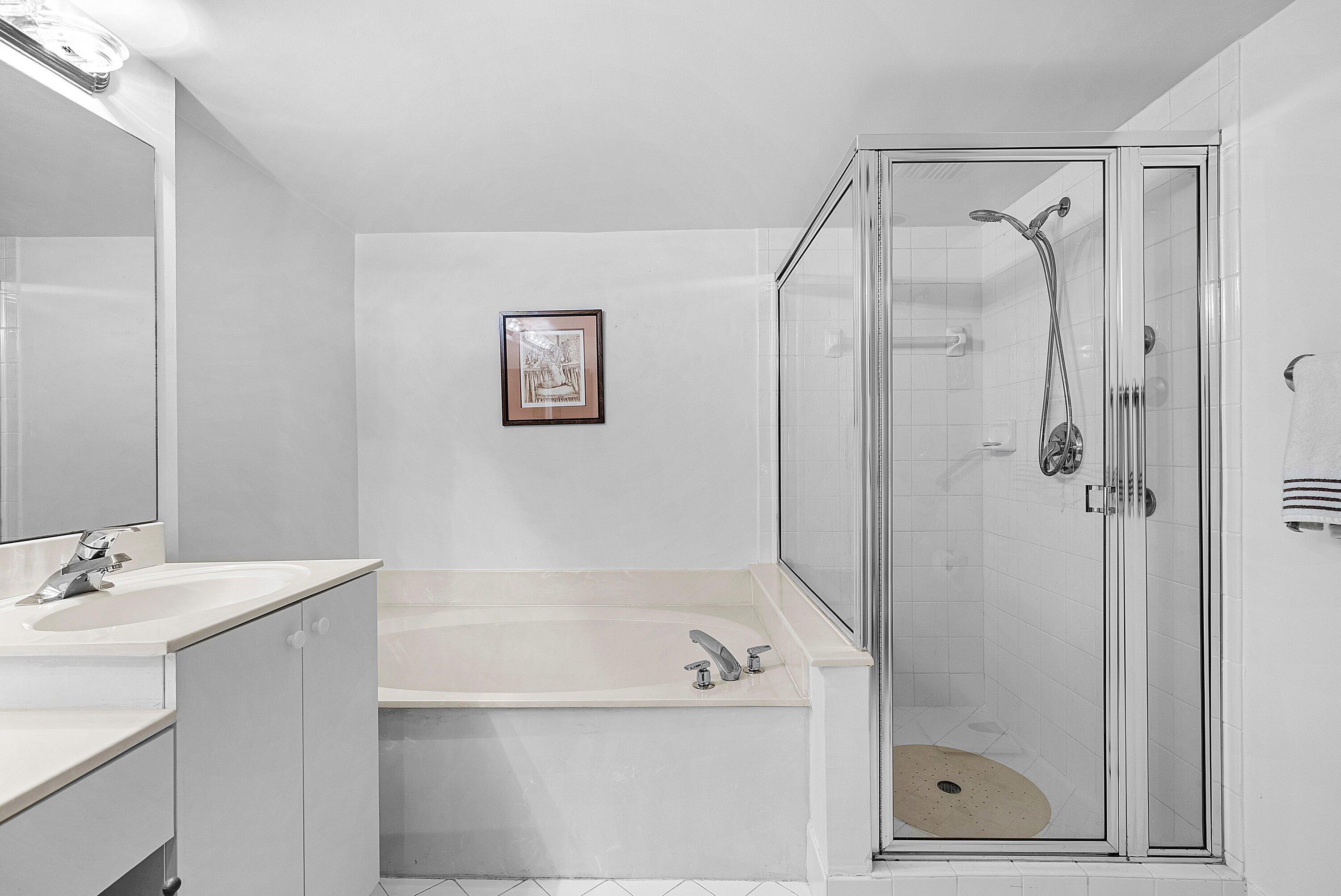 12560 Majesty Circle, Unit 303 Boynton Beach, FL 33437 - Photo 24 of 33 a bathroom with a shower a sink and a mirror