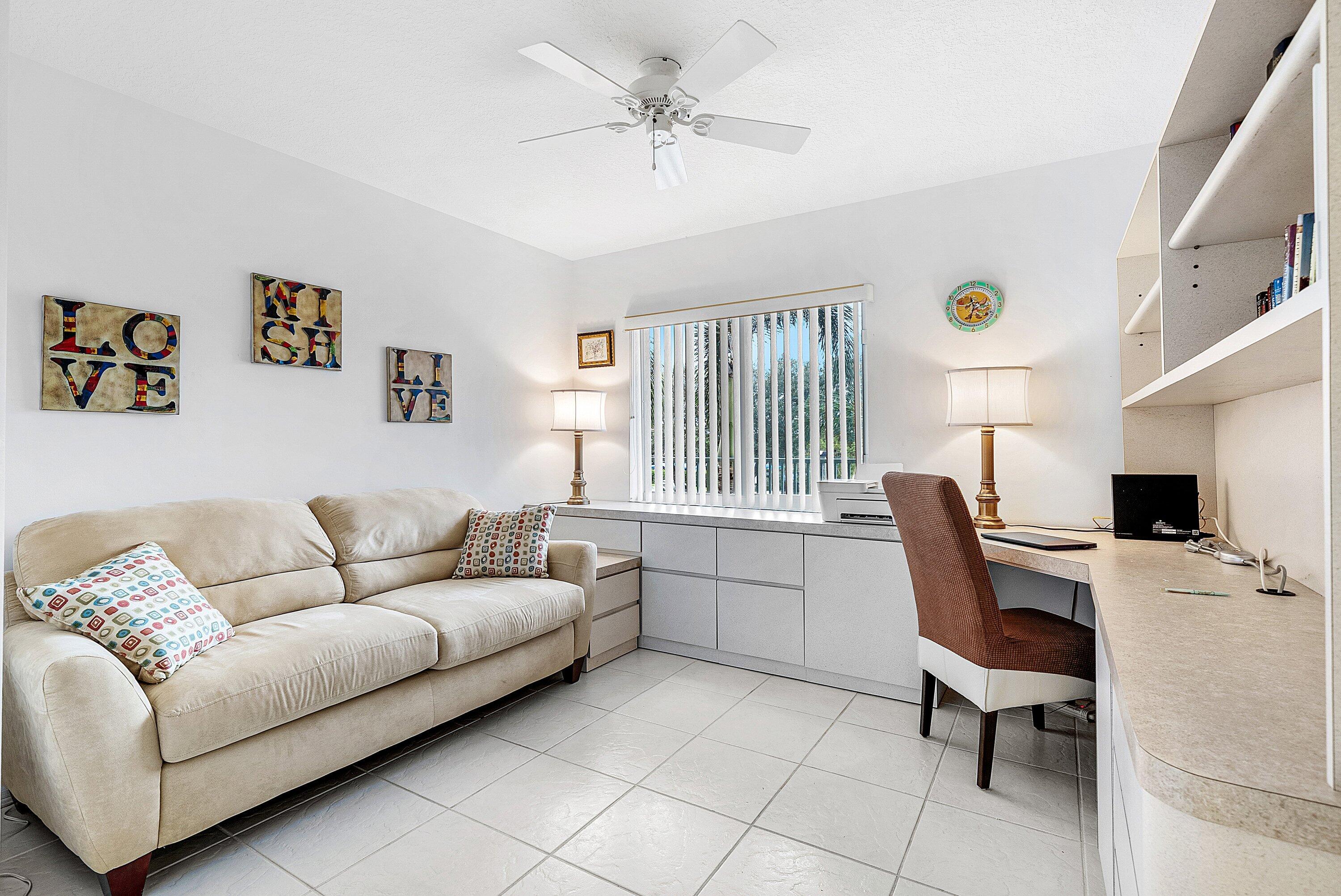 12560 Majesty Circle, Unit 303 Boynton Beach, FL 33437 - Photo 26 of 33 a living room with furniture and a flat screen tv