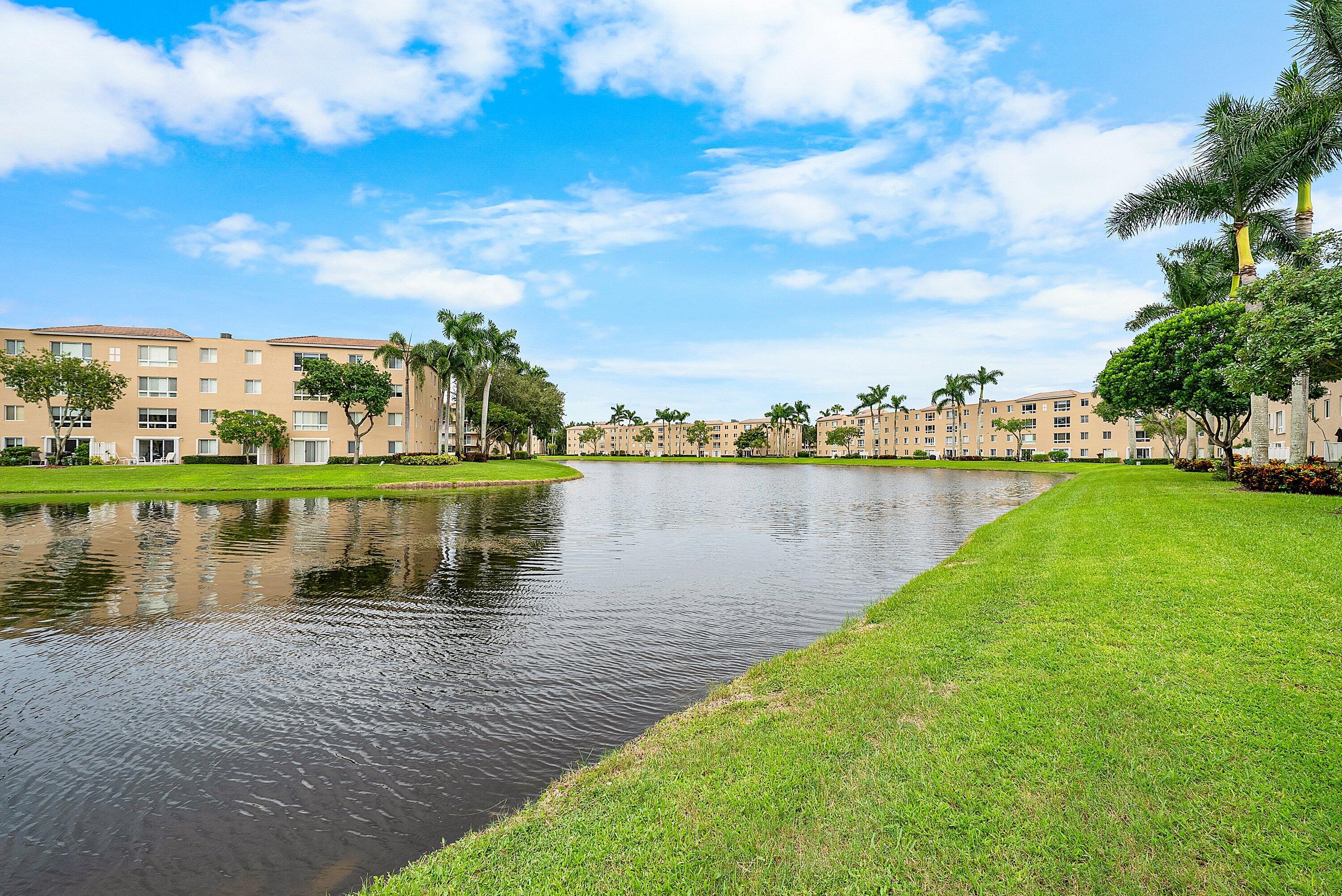 12560 Majesty Circle, Unit 303 Boynton Beach, FL 33437 - Photo 31 of 33 a view of a lake with houses in the back