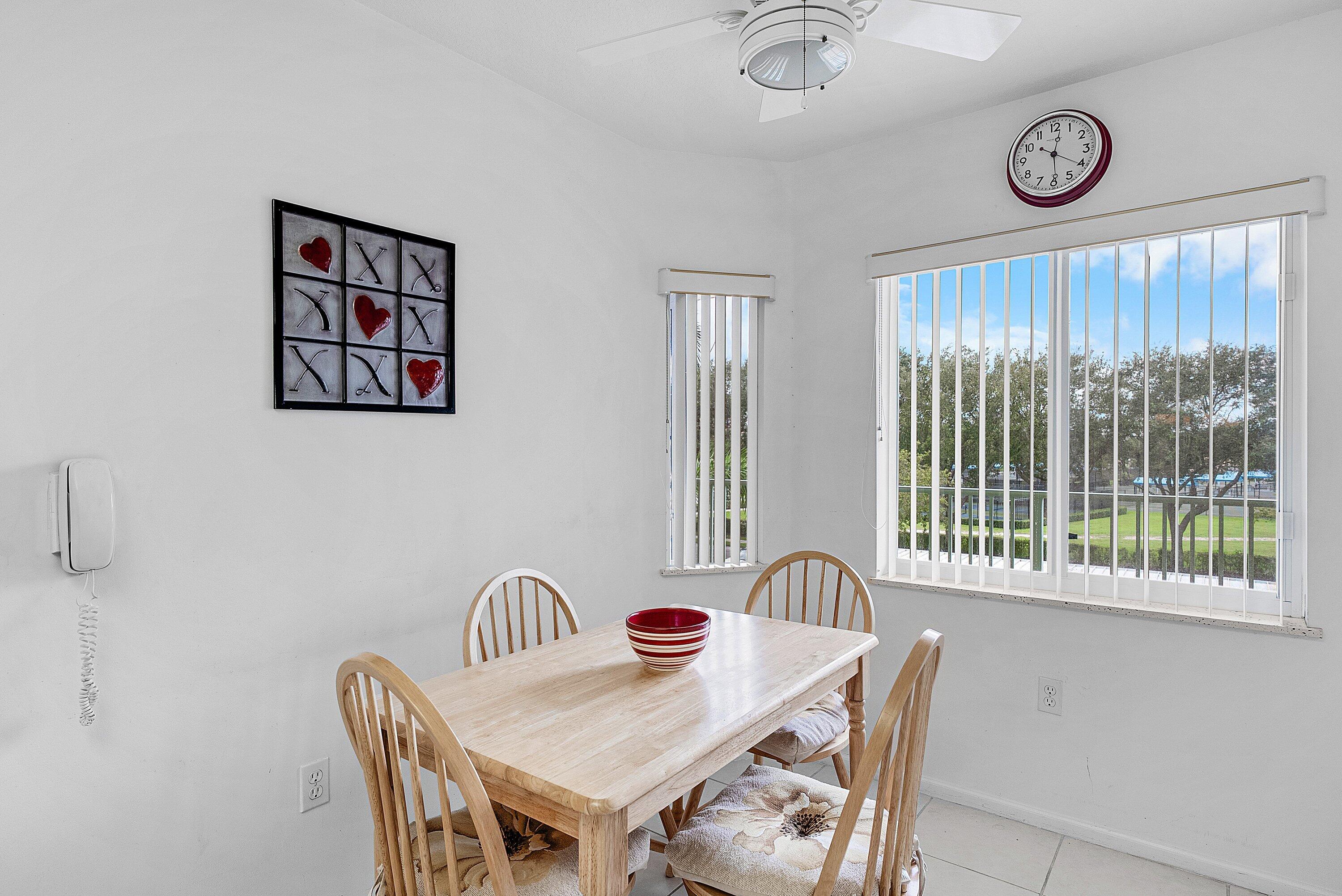12560 Majesty Circle, Unit 303 Boynton Beach, FL 33437 - Photo 7 of 33 a view of a dining room with furniture window and outside view