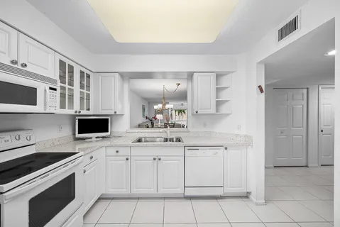 a kitchen with stainless steel appliances granite countertop a sink and a stove