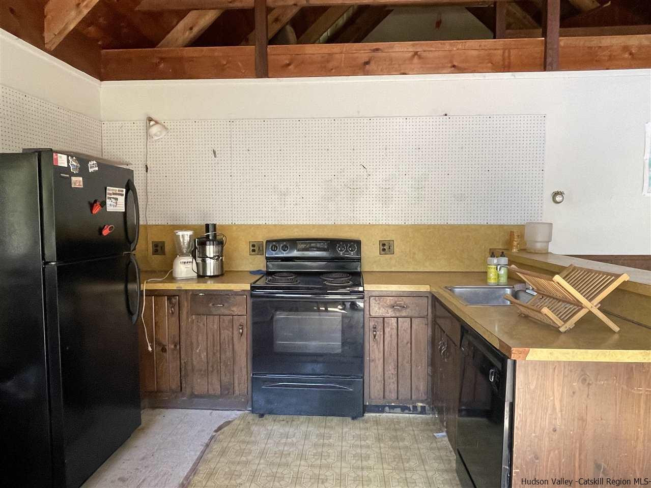 187 Deer Run Road Roxbury, NY 12421 - Photo 12 of 28 a kitchen with a stove and a refrigerator