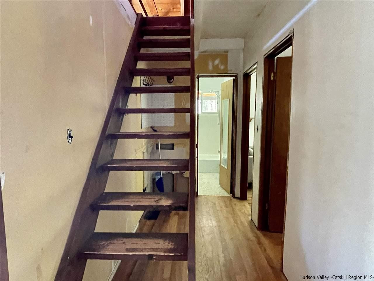187 Deer Run Road Roxbury, NY 12421 - Photo 15 of 28 a view of staircase and living room with wooden floor
