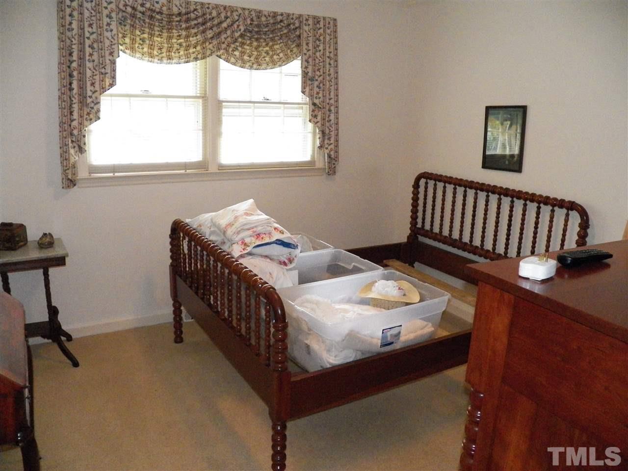 5204 Knollwood Road Raleigh, NC 27609 - Photo 13 of 25 a bedroom with a bed and a window