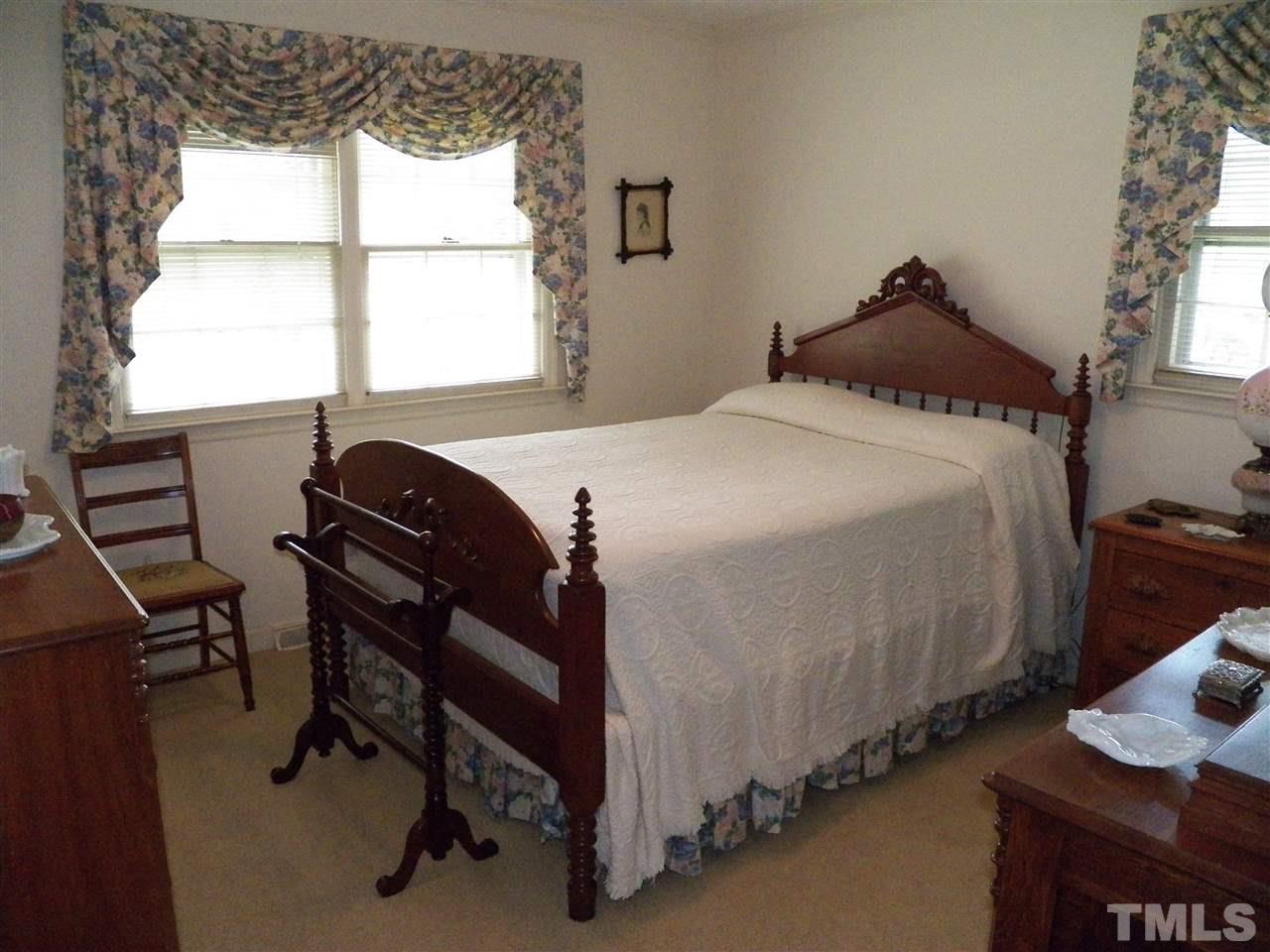 5204 Knollwood Road Raleigh, NC 27609 - Photo 15 of 25 a bedroom with a bed and a window