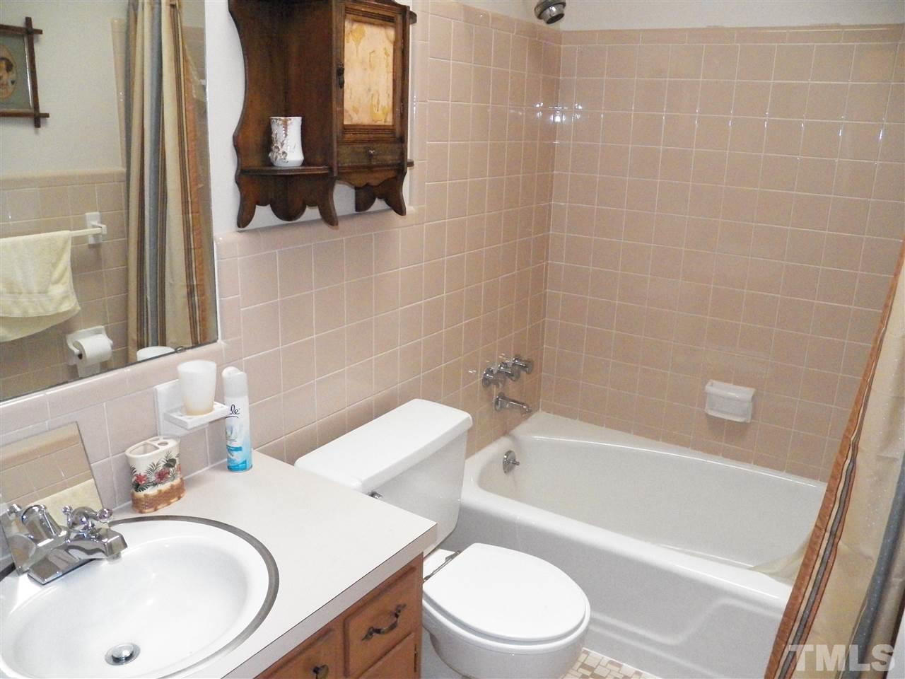 5204 Knollwood Road Raleigh, NC 27609 - Photo 16 of 25 a bathroom with a sink a toilet and shower