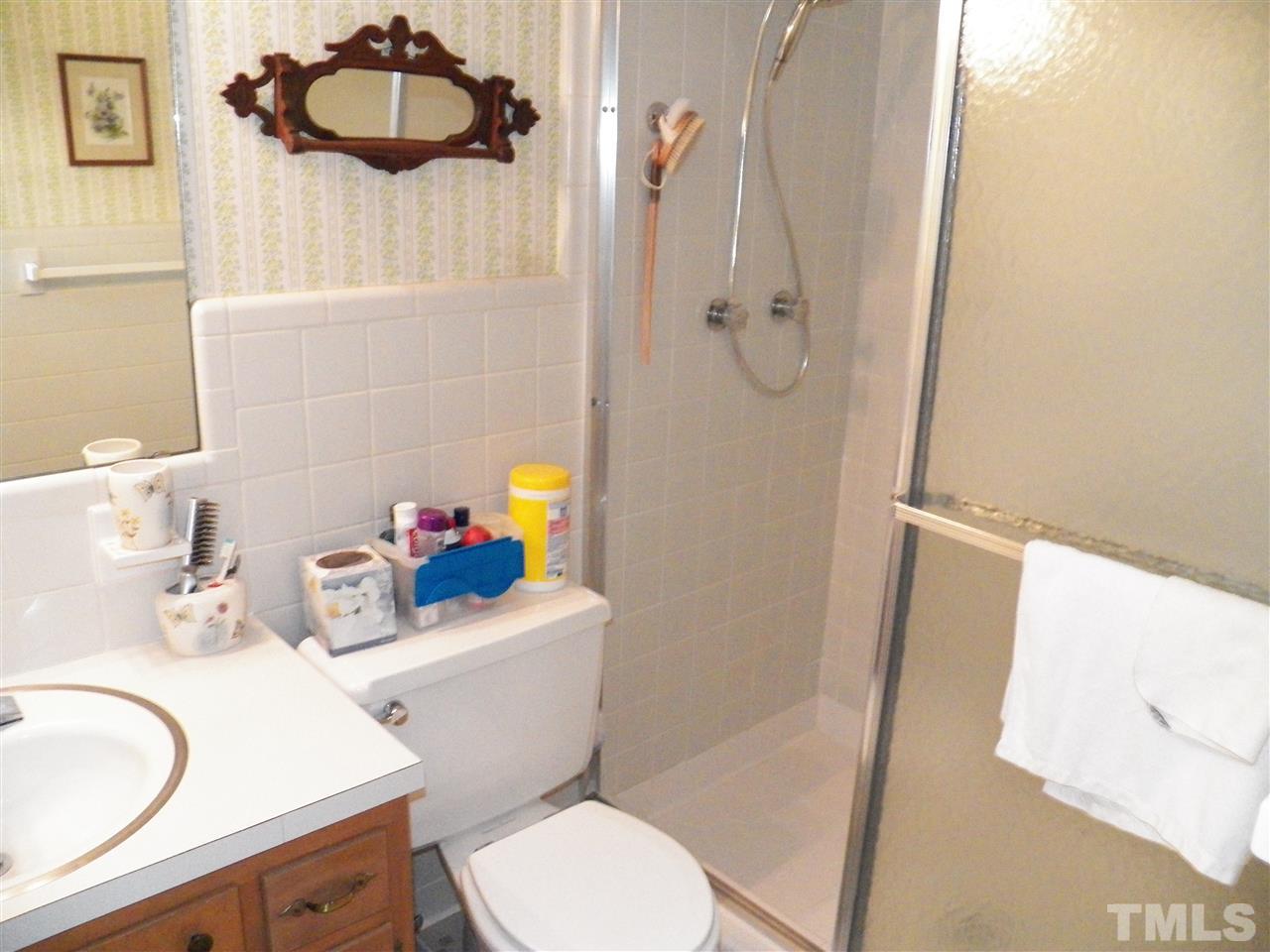 5204 Knollwood Road Raleigh, NC 27609 - Photo 18 of 25 a bathroom with a sink a toilet and shower curtain