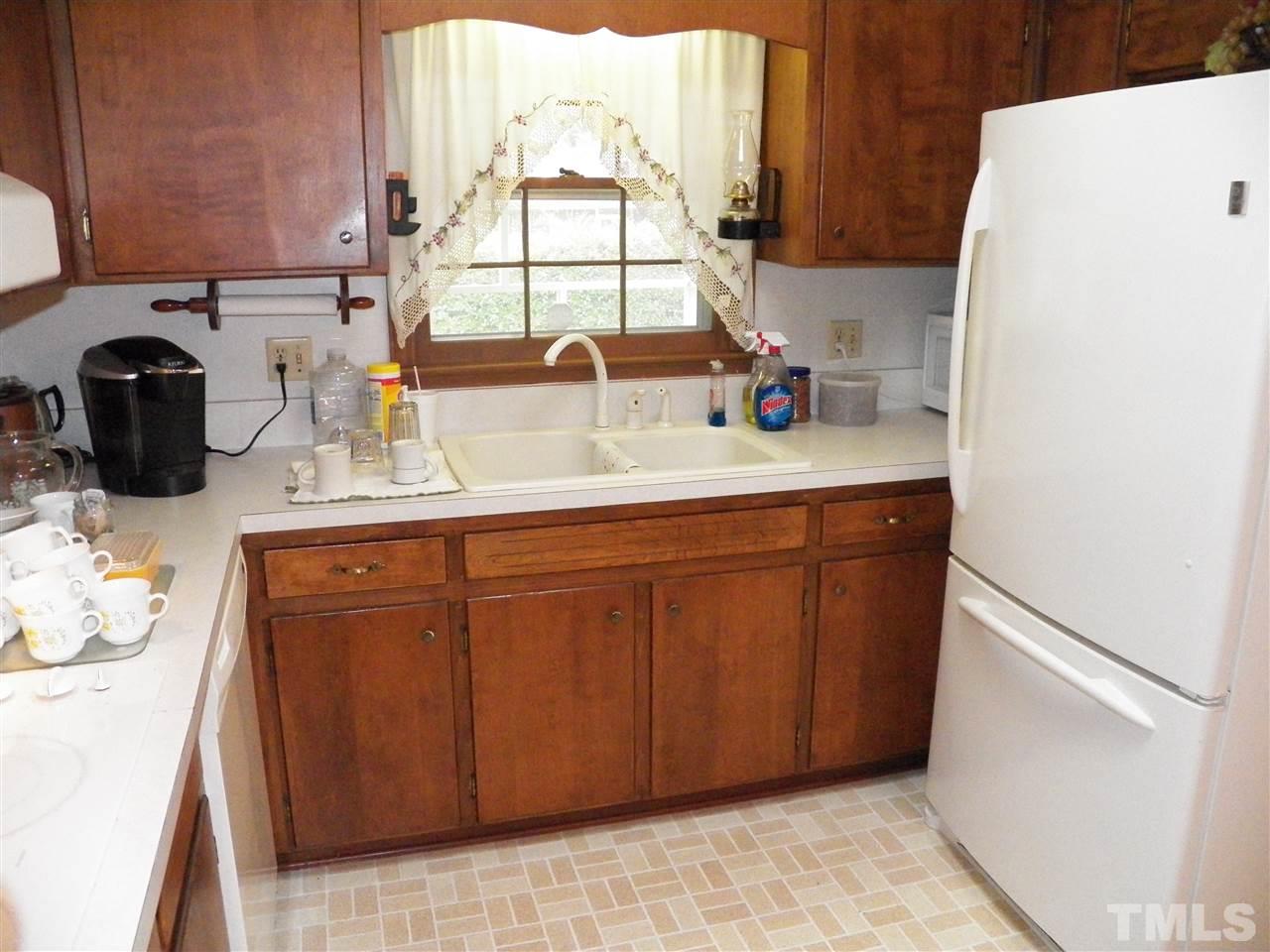 5204 Knollwood Road Raleigh, NC 27609 - Photo 4 of 25 a kitchen with a sink and a window