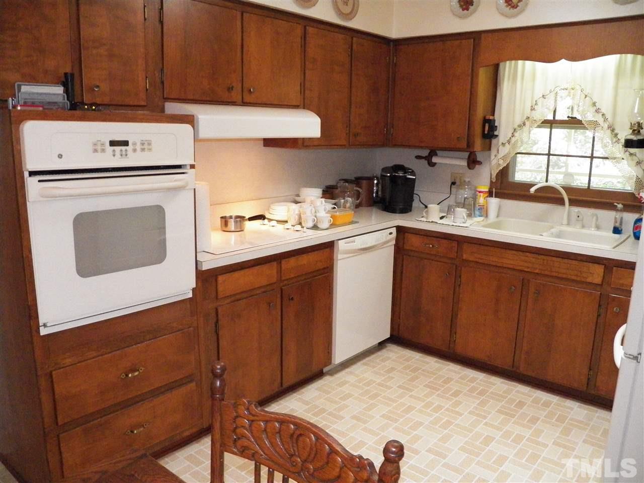 5204 Knollwood Road Raleigh, NC 27609 - Photo 5 of 25 a kitchen with a cabinets and white appliances
