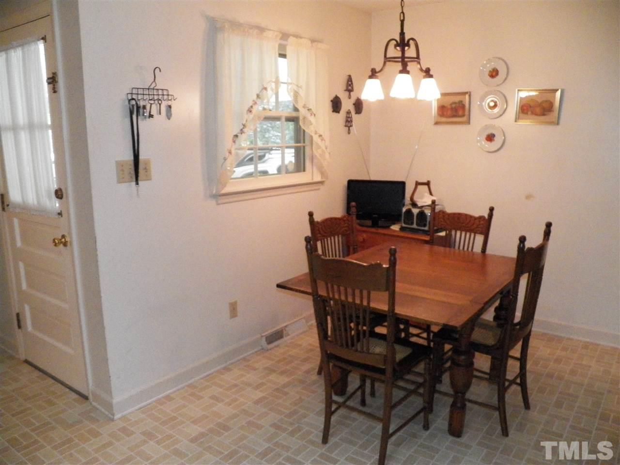 5204 Knollwood Road Raleigh, NC 27609 - Photo 6 of 25 a view of a dining room with furniture and a chandelier