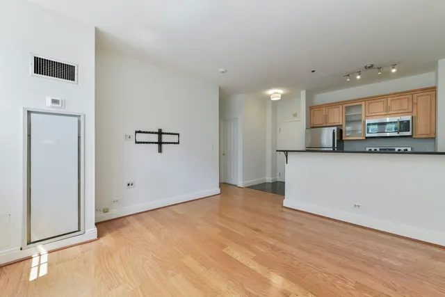 a view of a kitchen with a sink and a refrigerator