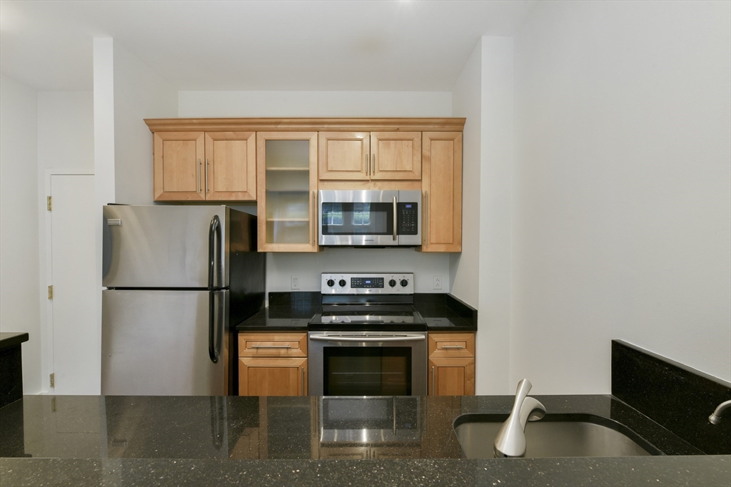 534 Beacon Street, Unit 103 Boston, MA 02215 - Photo 2 of 12 a kitchen with a stove and a refrigerator