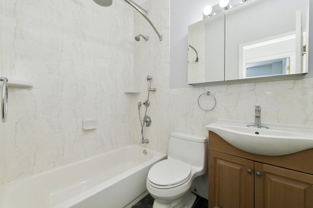 534 Beacon Street, Unit 103 Boston, MA 02215 - Photo 10 of 12 a bathroom with a sink a toilet and shower