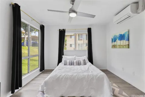 a bedroom with a large bed and a window