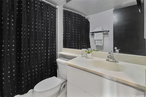 a bathroom with a sink a toilet a shower and a mirror