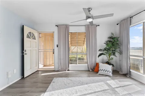 a living room with furniture and a potted plant