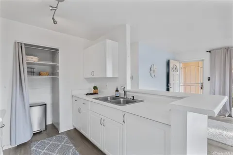 a kitchen with a sink cabinets and window