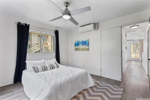 a bedroom with a large bed and a chandelier