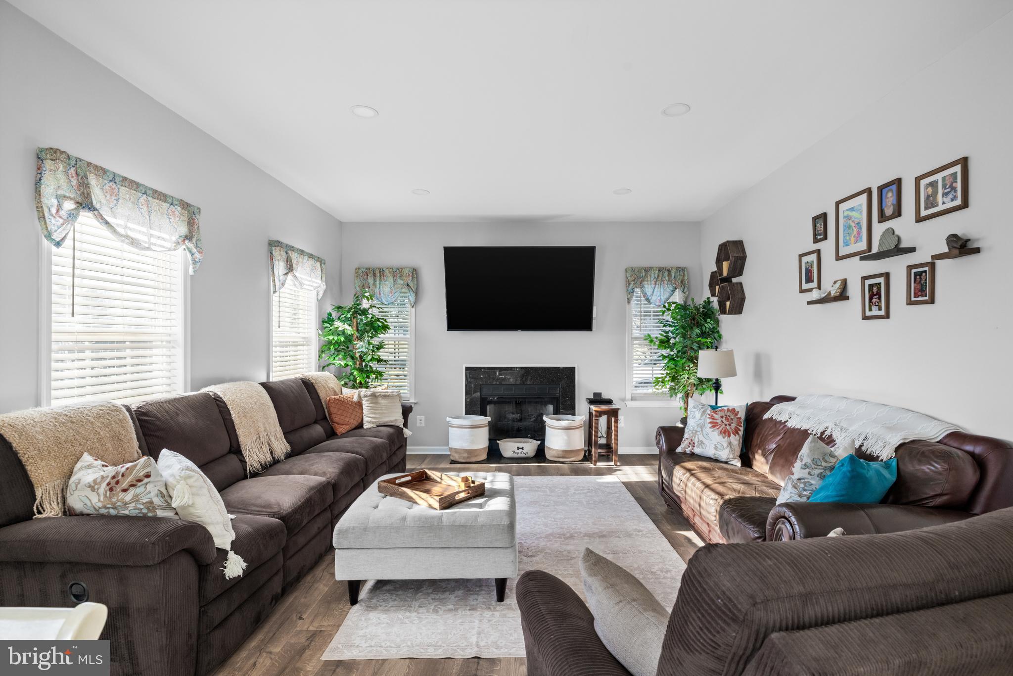 404 Pinnacle Drive Bunker Hill, WV 25413 - Photo 12 of 36 a living room with furniture a fireplace and a flat screen tv