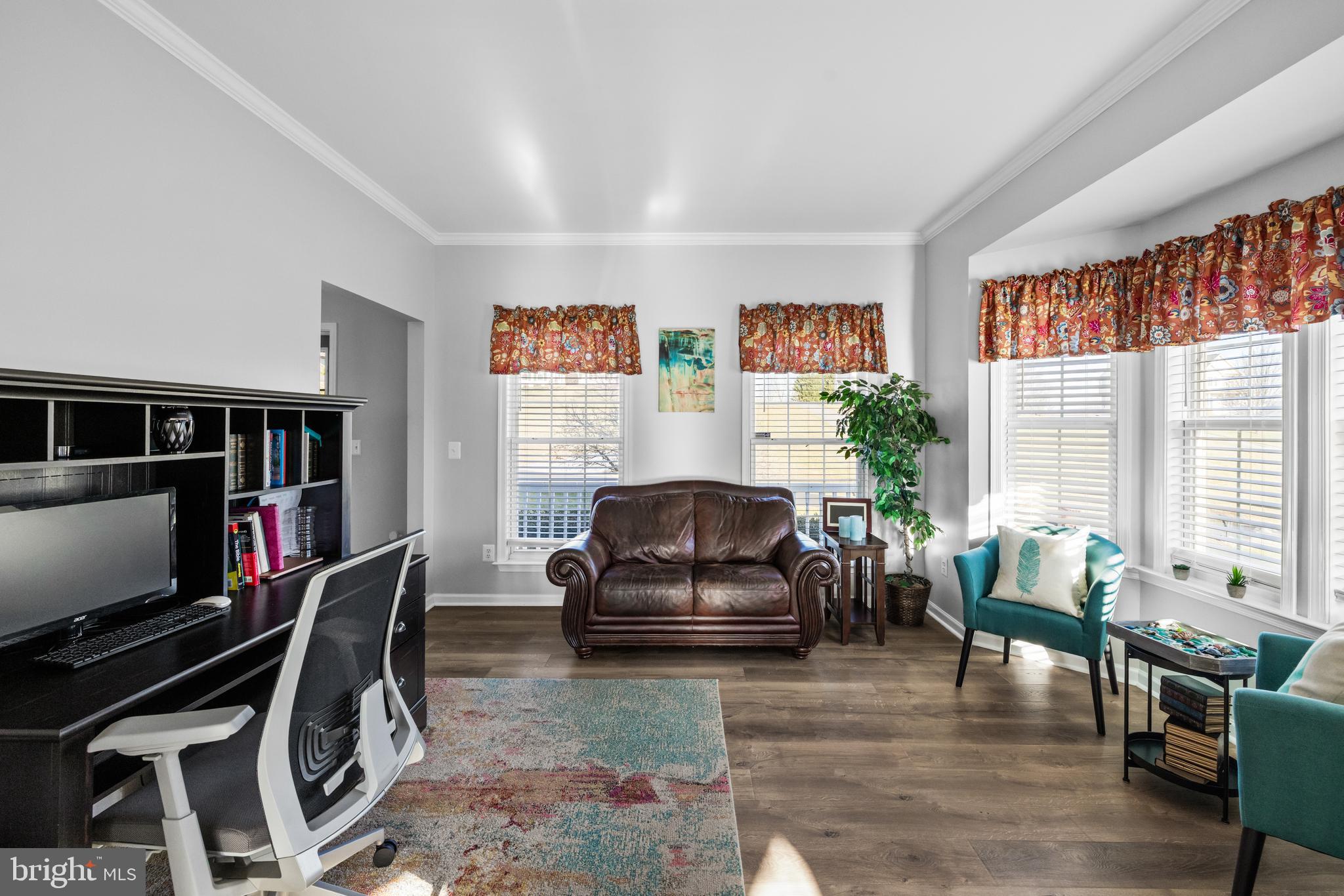 404 Pinnacle Drive Bunker Hill, WV 25413 - Photo 14 of 36 a living room with furniture a flat screen tv and a bookshelf