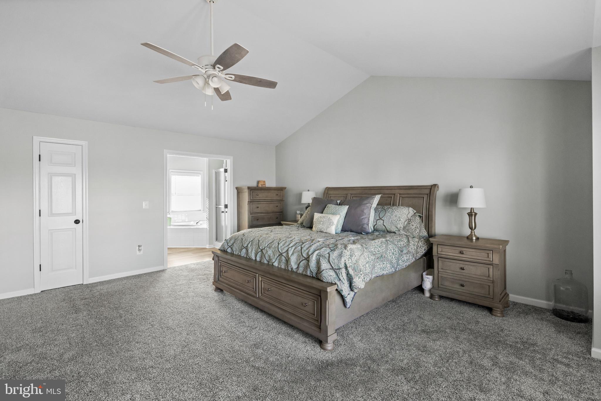 404 Pinnacle Drive Bunker Hill, WV 25413 - Photo 18 of 36 a spacious bedroom with a bed and window