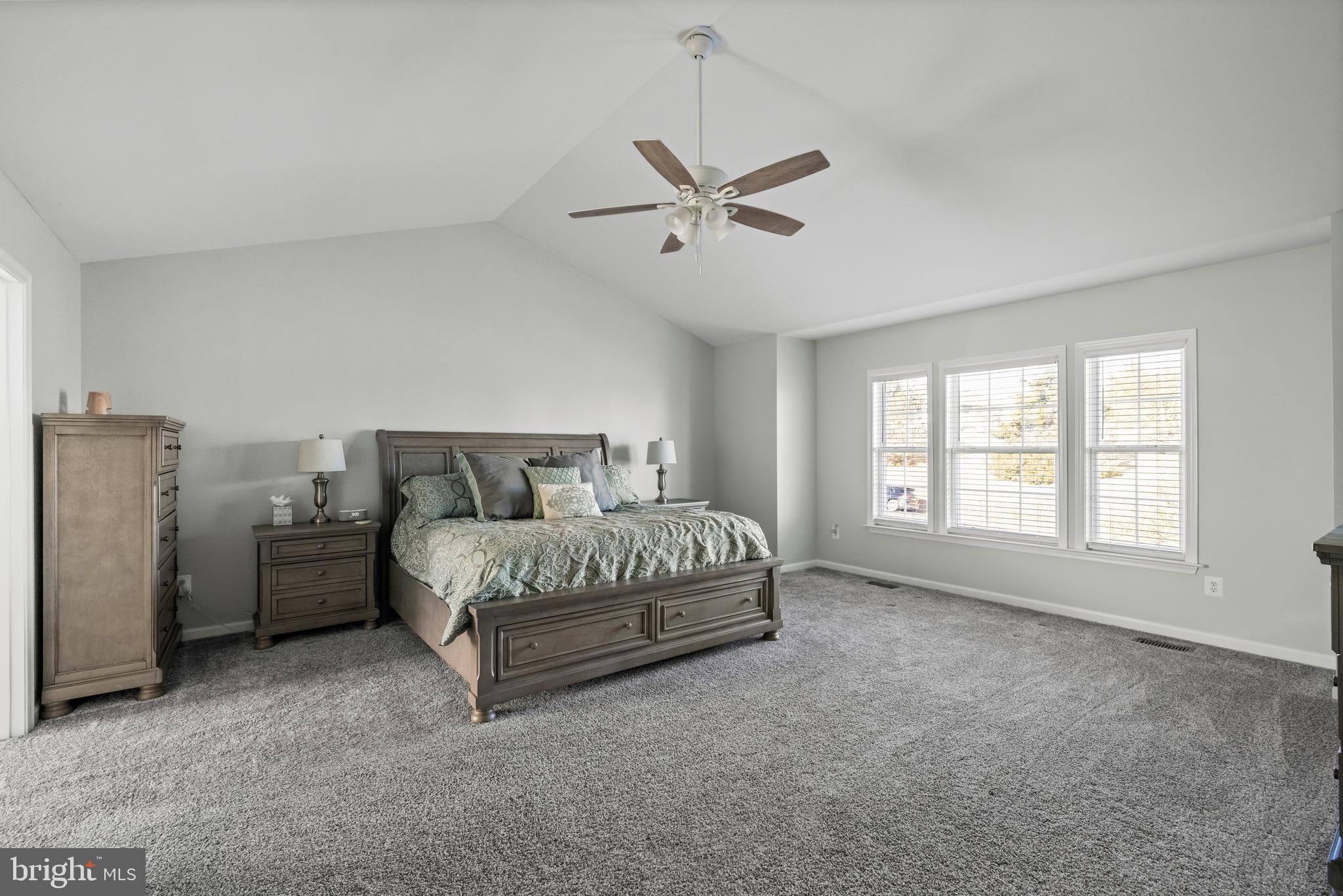 404 Pinnacle Drive Bunker Hill, WV 25413 - Photo 19 of 36 a spacious bedroom with a bed and a window