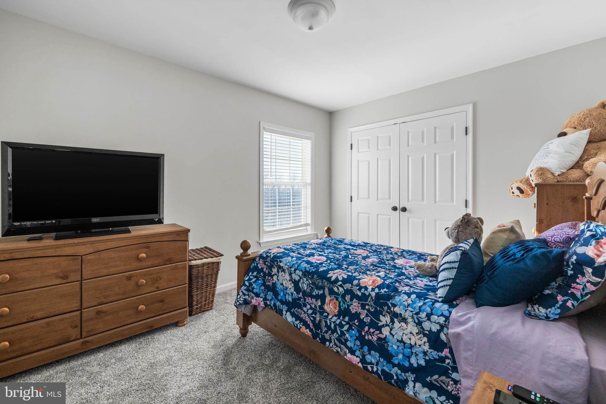 404 Pinnacle Drive Bunker Hill, WV 25413 - Photo 22 of 36 a bedroom with a bed and a flat screen tv