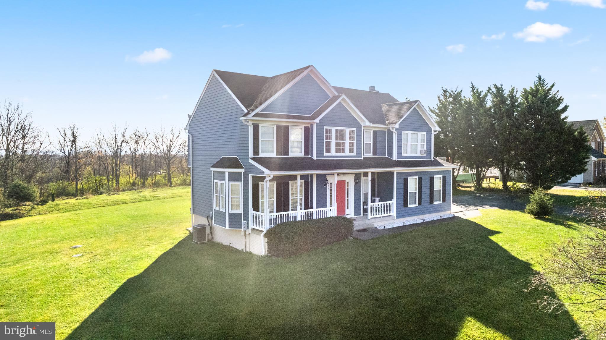 404 Pinnacle Drive Bunker Hill, WV 25413 - Photo 34 of 36 a view of a house with a big yard and large trees