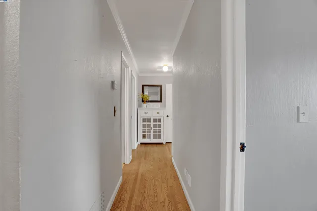 a view of a hallway with wooden floor