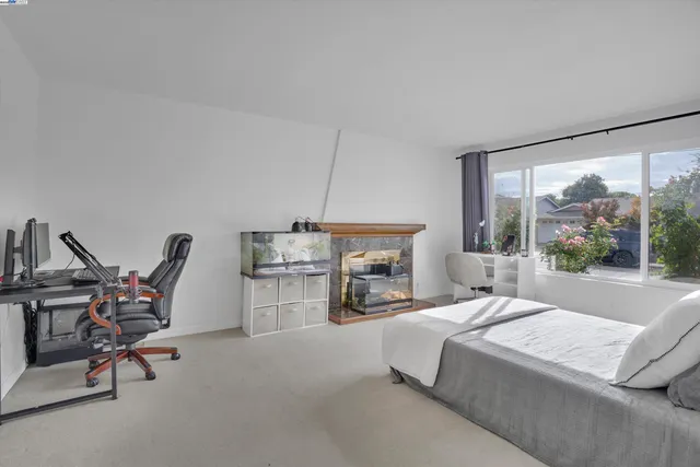 a bed room with a bed and a chair