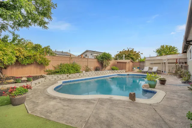 a view of a swimming pool with a yard