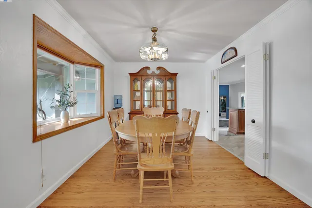 a view of a dining room with furniture wooden floor and a chandelier