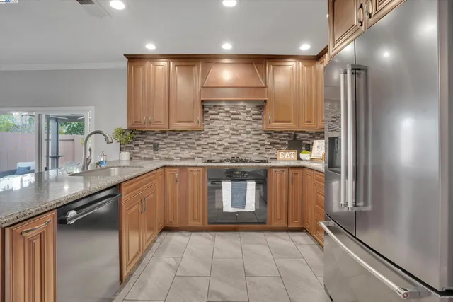 a large kitchen with a sink and a large mirror