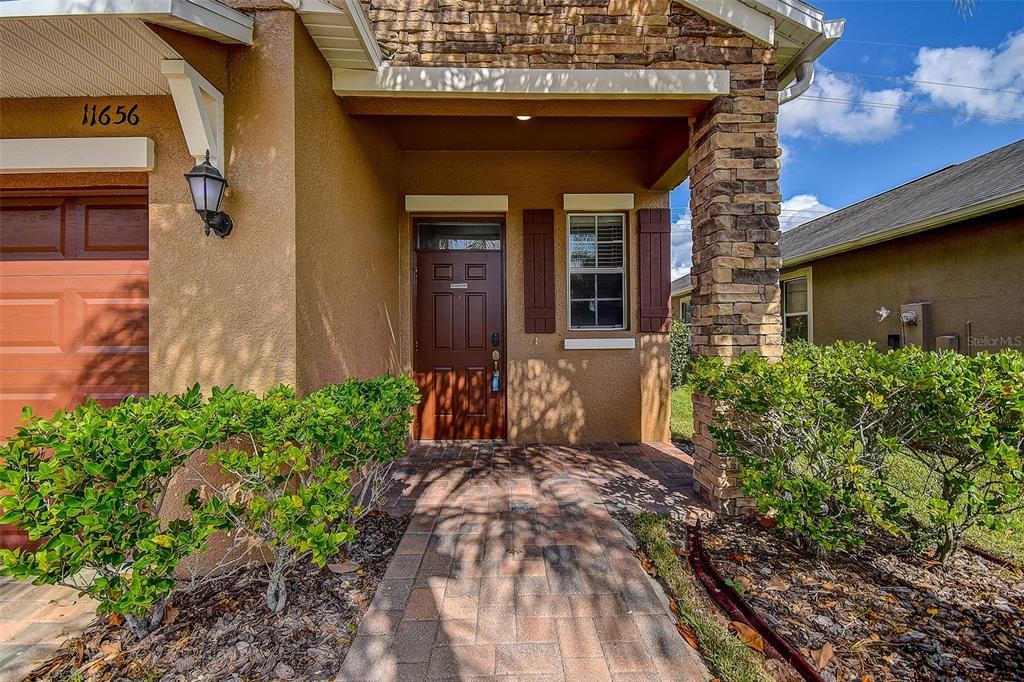 11656 Lake Boulevard New Port Richey, FL 34655 - Photo 3 of 55 a front view of a house with a yard