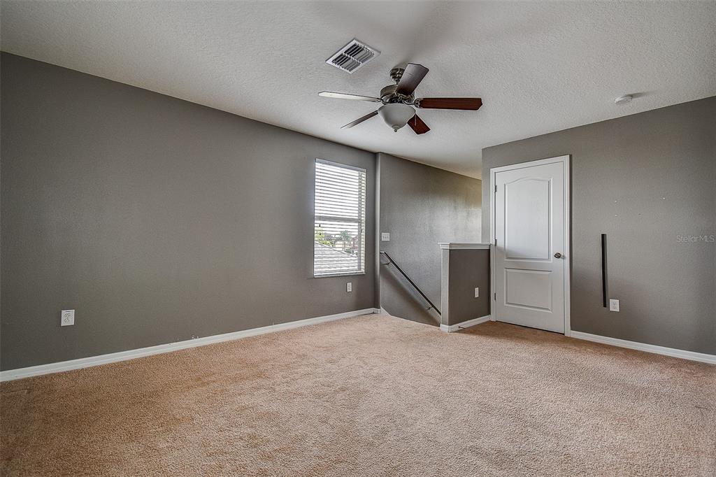 11656 Lake Boulevard New Port Richey, FL 34655 - Photo 36 of 55 a view of a livingroom with a ceiling fan and window