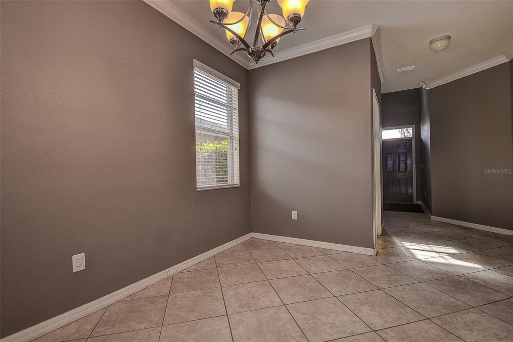11656 Lake Boulevard New Port Richey, FL 34655 - Photo 7 of 55 a view of an empty room with window and chandelier fan