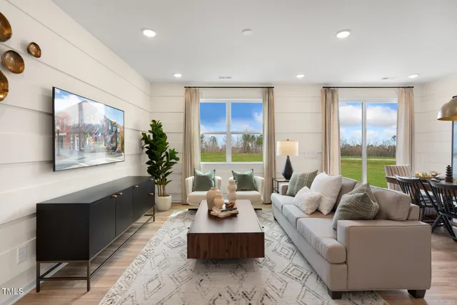 a living room with furniture and large windows