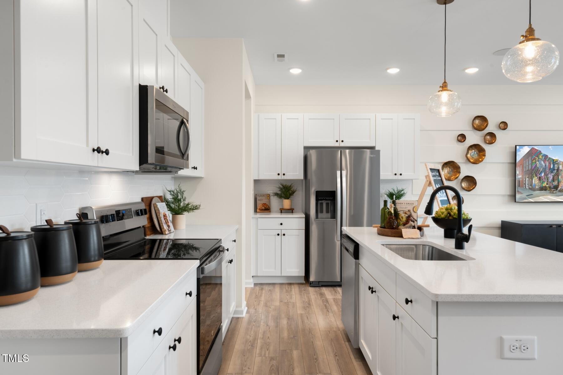 159 Siebold Street Garner, NC 27529 - Photo 22 of 36 a kitchen with a sink a stove and refrigerator