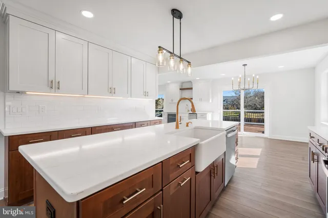 a kitchen with a sink a stove and a wooden floor