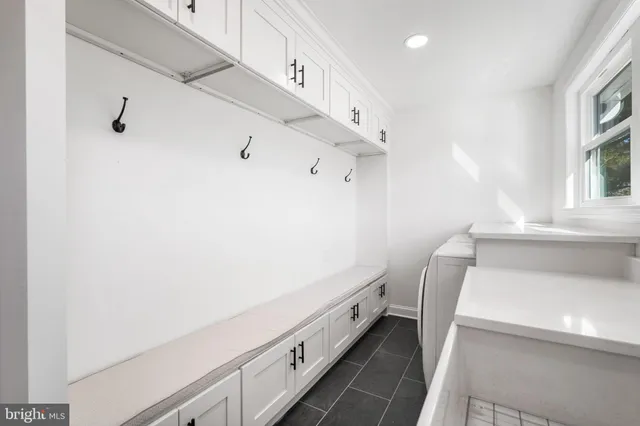 a bathroom with a double vanity sink and a toilet