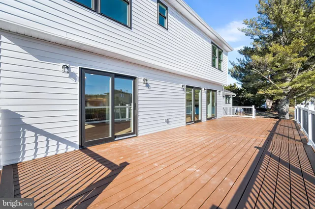 a view of backyard with deck and wooden floor