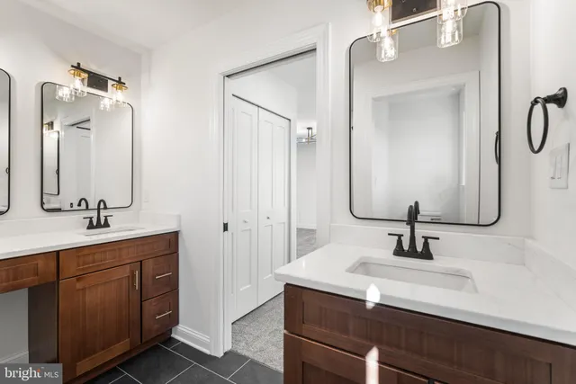 a bathroom with a double vanity sink double vanity and mirror