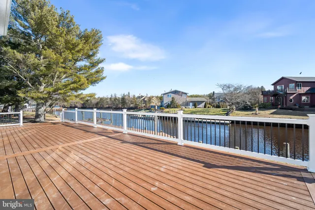 a view of a roof deck with wooden floor and fence