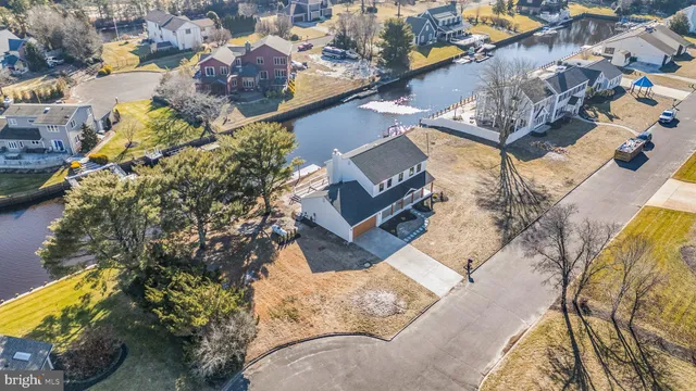 an aerial view of a house with a yard and lake view