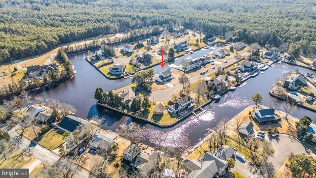 an aerial view of a house with a swimming pool and outdoor seating