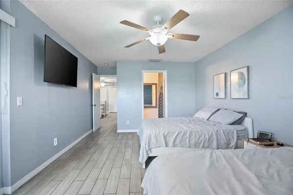 a bedroom with a large bed and a flat screen tv
