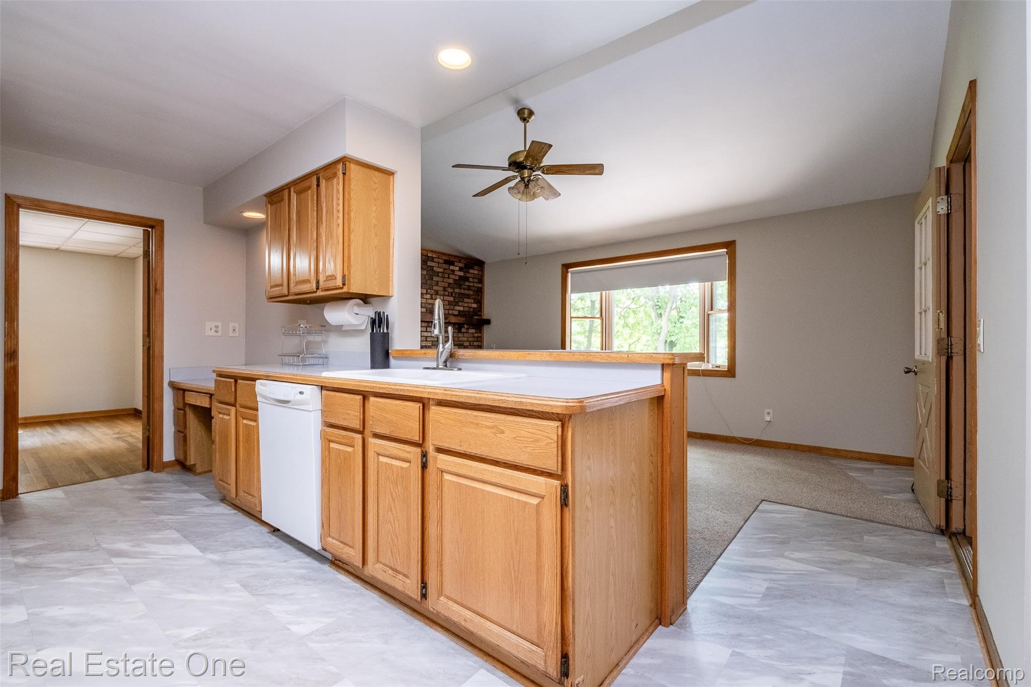 11030 Marshall Road South Lyon, MI 48178 - Photo 27 of 83 Kitchen featuring wood cabinetry, a white dishwasher, a stainless steel sink, and light-toned countertops