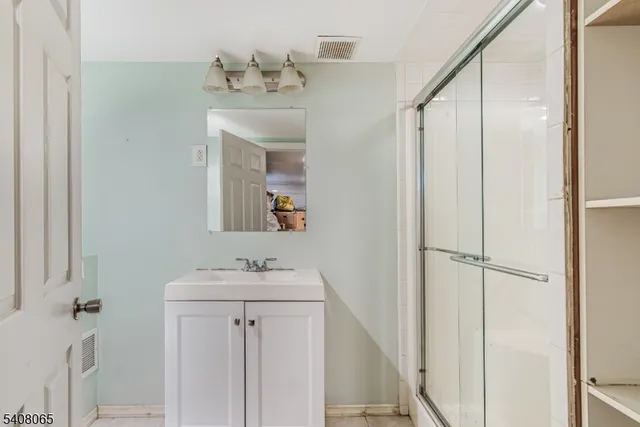 a bathroom with a sink a mirror and vanity