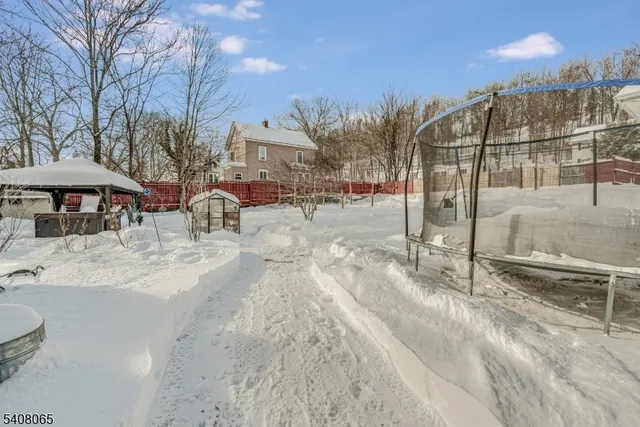 a view of a swimming pool with a patio and a yard