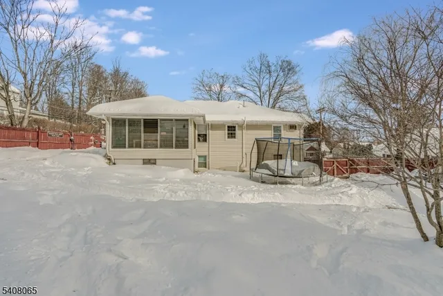 a white house with a large tree in front of it
